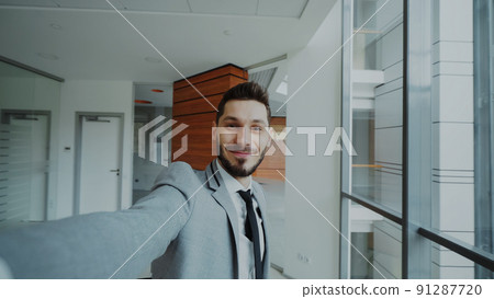 POV of young businessman in suit taking a selfie photo and have fun in modern office 91287720