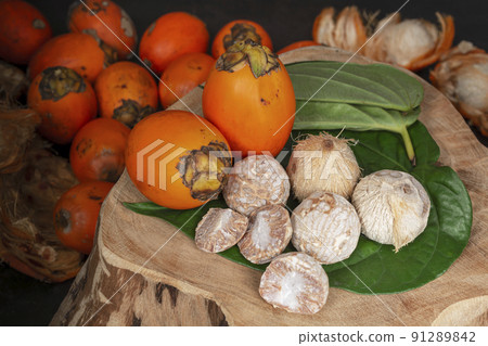 Betel nut or areca nut with betel leaf isolated on wooden background. Betel nut or areca nut with betel leaf isolated on wooden background. 91289842