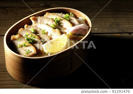 Yakiniku bento with pickles, cut lemon and pork jowl in magewappa 91291470