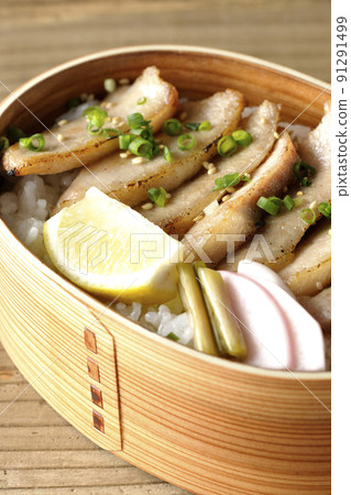 Yakiniku bento with pickles, cut lemon and pork jowl in magewappa 91291499