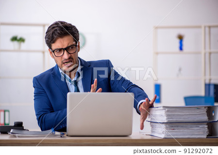 Young businessman employee and too much work in the office 91292072