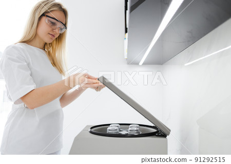 Medical cosmetologist opens a plasma-lifting centrifuge Medical cosmetologist opens a plasma-lifting centrifuge 91292515