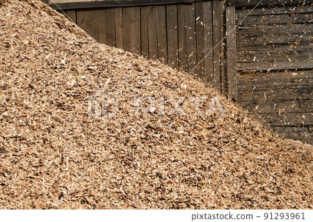 Large heaps of wood chips after pruning of trees and shrubs at the end of the winter season. Large heaps of wood chips after pruning of trees and shrubs at the end of the winter season. 91293961