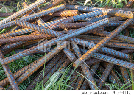 Metal fittings for reinforced concrete. Main construction materials. Background and rusty iron reinforcement rods. Red orange color of iron oxide on reinforcement bars Metal fittings for reinforced concrete. Main construction materials. Background and rusty iron reinforcement rods. Red orange color of iron oxide on reinforcement bars 91294112