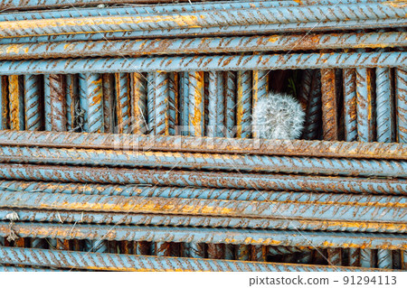 Metal fittings for reinforced concrete. Main construction materials. Background and rusty iron reinforcement rods. Red orange color of iron oxide on reinforcement bars 91294113