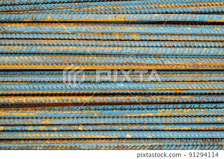 Metal fittings for reinforced concrete. Main construction materials. Background and rusty iron reinforcement rods. Red orange color of iron oxide on reinforcement bars Metal fittings for reinforced concrete. Main construction materials. Background and rusty iron reinforcement rods. Red orange color of iron oxide on reinforcement bars 91294114