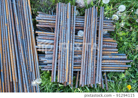 Metal fittings for reinforced concrete. Main construction materials. Background and rusty iron reinforcement rods. Red orange color of iron oxide on reinforcement bars 91294115