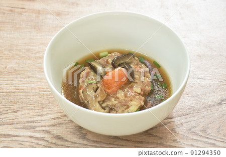steamed chop pork topping salty egg yolk with mushroom in gravy sauce on bowl  91294350