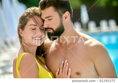 Romantic lady hugging a young dark-haired man Romantic lady hugging a young dark-haired man 91295375