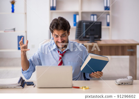 Young male employee working in the office Young male employee working in the office 91296602