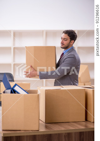 Young male employee in office relocation concept Young male employee in office relocation concept 91296616