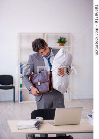 Young male employee in oversleeping concept Young male employee in oversleeping concept 91296691