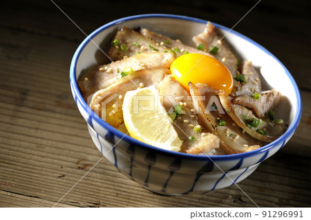 Pork toro bowl with cut lemon and egg yolk, grilled meat bowl Pork toro bowl with cut lemon and egg yolk, grilled meat bowl 91296991