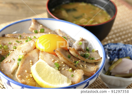 Pork toro bowl with cut lemon and egg yolk, grilled meat bowl and turnip new incense and miso soup Pork toro bowl with cut lemon and egg yolk, grilled meat bowl and turnip new incense and miso soup 91297358