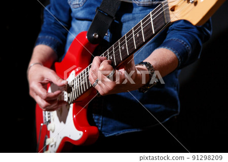 elderly man in blue denim shirt plays the electric guitar elderly man in blue denim shirt plays the electric guitar 91298209