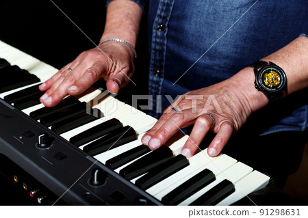 elderly man in blue denim shirt plays the keys on stage elderly man in blue denim shirt plays the keys on stage 91298631