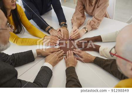 Diverse multicultural group of people holding their hands on the Holy Bible and praying 91298849