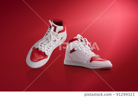 Strolling sports shoes on red background. Sneakers or trainers isolated. Athletic shoes. fitness, sport, training concept. Urban fashion Strolling sports shoes on red background. Sneakers or trainers isolated. Athletic shoes. fitness, sport, training concept. Urban fashion 91299321