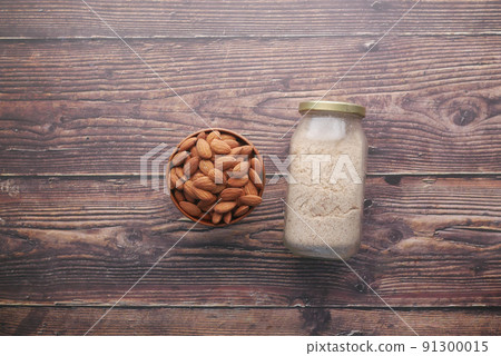 almond powder and almond in a jar on table, almond powder and almond in a jar on table, 91300015