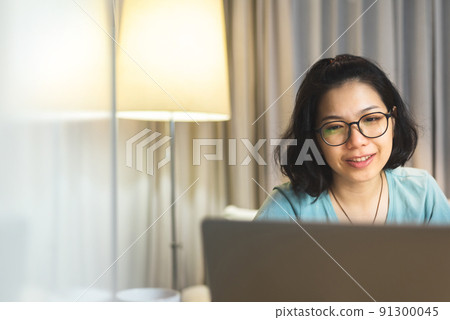 Beautiful young Chinese woman using laptop at home, Asian Female student 91300045
