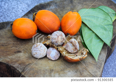 Betel nut with betel leaf isolated on wooden background. Copy space Betel nut with betel leaf isolated on wooden background. Copy space 91300385