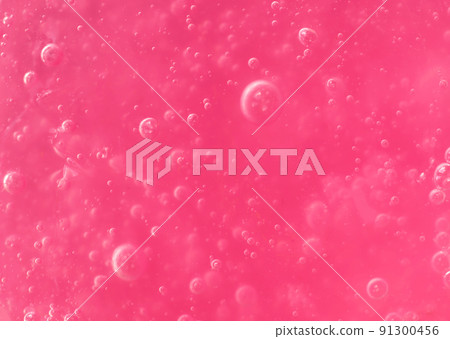 Texture of transparent pink gel with air bubbles and waves on white background. Concept of skin moisturizing, body care, and prevention of viruses. Liquid beauty product closeup. Backdrop, flat lay Texture of transparent pink gel with air bubbles and waves on white background. Concept of skin moisturizing, body care, and prevention of viruses. Liquid beauty product closeup. Backdrop, flat lay 91300456