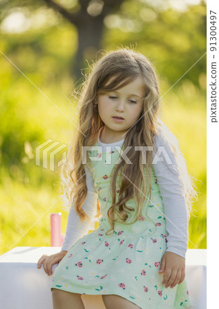 girl in nature with a glass of orange juice 91300497