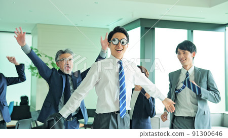 A business group dancing in the office A business group dancing in the office 91300646