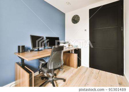 Interior of light home office with wooden desk and shelf rack near window with curtains 91301489