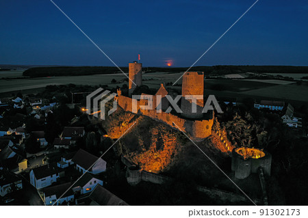 Image of illuminated Muenzenberg castle ruin in Germany in the evening Image of illuminated Muenzenberg castle ruin in Germany in the evening 91302173
