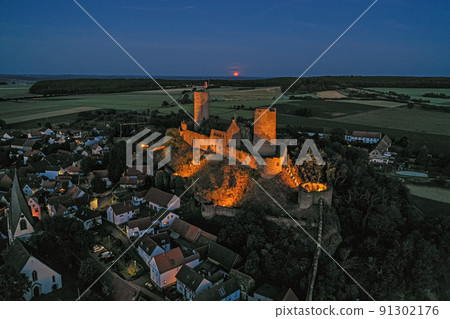 Image of illuminated Muenzenberg castle ruin in Germany in the evening 91302176