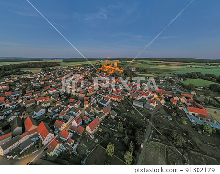 Drone image of Muenzenberg with illuminated castle ruins in Germany Drone image of Muenzenberg with illuminated castle ruins in Germany 91302179