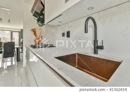 Spacious bright kitchen with dining area, modern design and panoramic windows 91302659