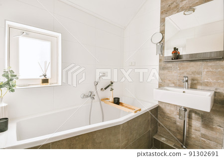 Stylish bathroom with white ceramic bath and sink 91302691