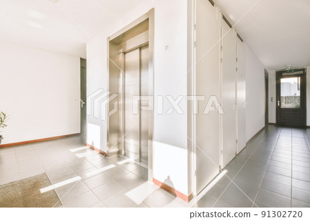 Corridor of contemporary apartment with doorway leading to terrace Corridor of contemporary apartment with doorway leading to terrace 91302720