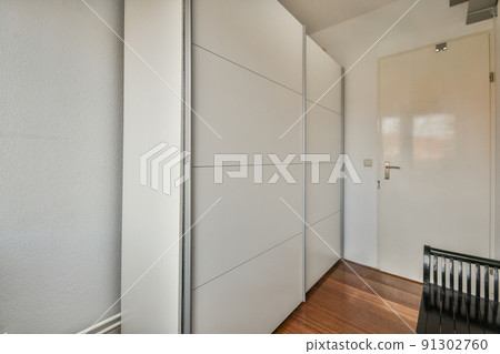 An empty bright room with cabinets made in a modern style An empty bright room with cabinets made in a modern style 91302760