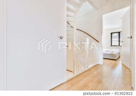 Hallway with white walls with white wooden stairs Hallway with white walls with white wooden stairs 91302922