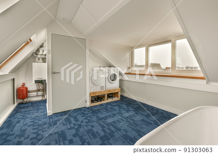 Sinks with washing machine and clean bathtub located near shower box with glass door in modern bathroom with blue tiled floors 91303063