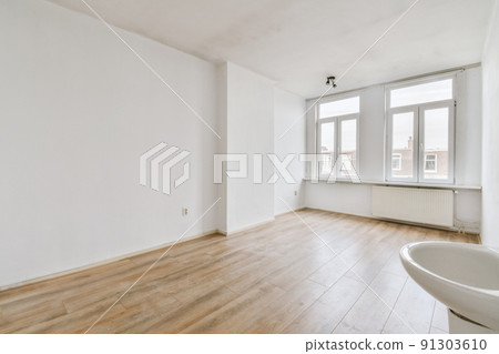 Plastic window and radiator on white wall in empty light room at home Plastic window and radiator on white wall in empty light room at home 91303610