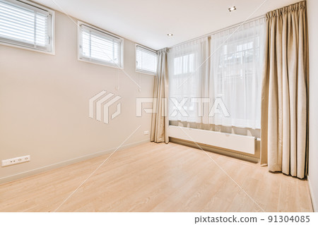 Plastic window and radiator on white wall in empty light room at home Plastic window and radiator on white wall in empty light room at home 91304085