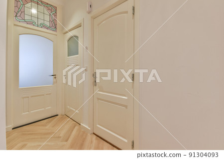 Light narrow hallway with many doors in white walls and glowing lamp over lumber floor 91304093
