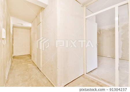 Interior of modern flat in minimal style with narrow empty corridor illuminated by lamps Interior of modern flat in minimal style with narrow empty corridor illuminated by lamps 91304237