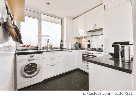 Modern home kitchen interior design in loft style apartment with white furniture and appliances Modern home kitchen interior design in loft style apartment with white furniture and appliances 91304531