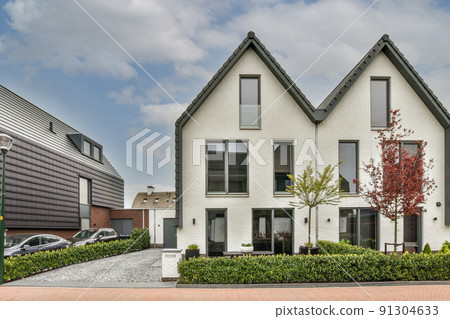 Panoramic view of houses an empty sidewalk street with trees and lanterns 91304633