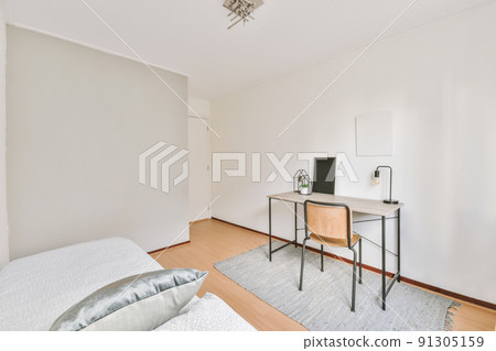Single bed,wooden office table and chair in a simple bedroom Single bed,wooden office table and chair in a simple bedroom 91305159