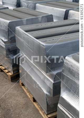 Gray curb stone in a stack. Preparing to repair the road Gray curb stone in a stack. Preparing to repair the road 91305271
