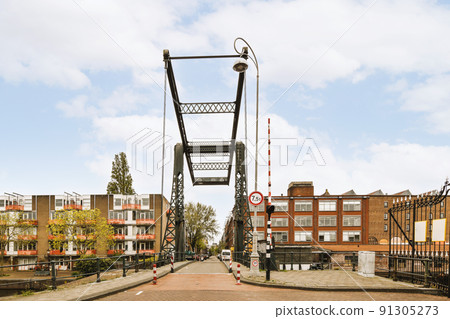 Panorama view of brick houses from an empty sidewalk street with cars, trees and lanterns 91305273