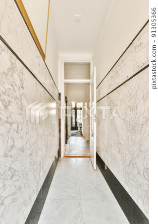 Light narrow hallway with many doors in white walls and glowing lamp over lumber floor 91305366