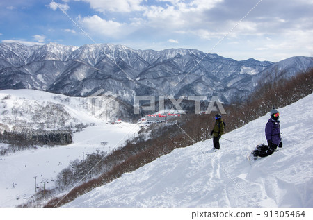 Hotel and blue sky seen from Hakuba Cortina Ski Resort's Hieda Forest Course in Otari Village, Kita Azumino County, Nagano Prefecture 91305464