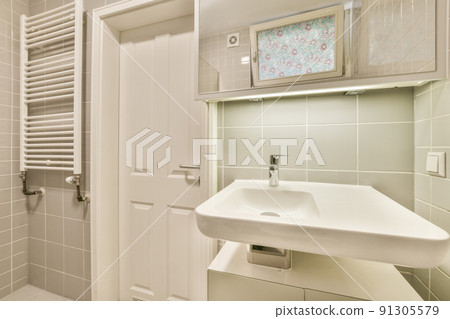 Interior of contemporary bathroom with shower, toilet and sink in minimal style in flat Interior of contemporary bathroom with shower, toilet and sink in minimal style in flat 91305579